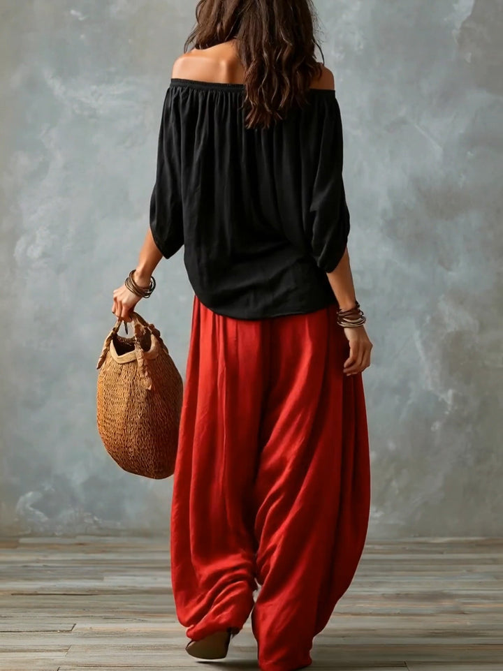 Top Negro Off-Shoulder y Pantalones Lantern Rojos de Corte Suelto