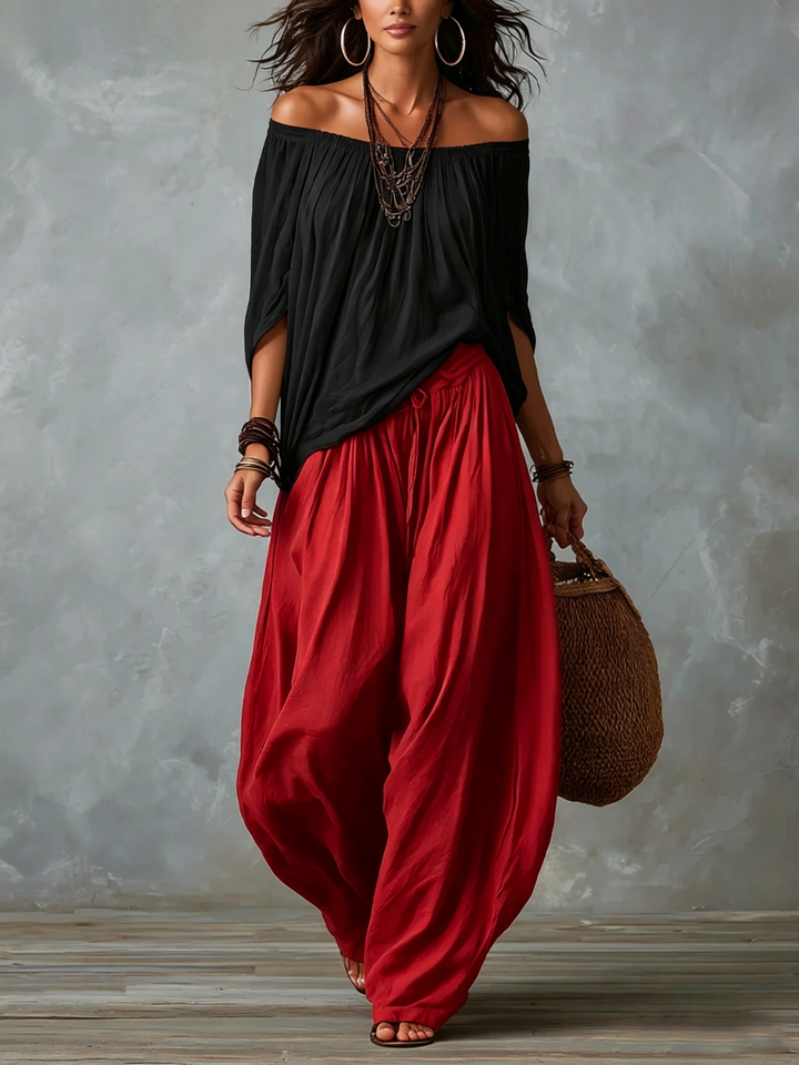 Top Negro Off-Shoulder y Pantalones Lantern Rojos de Corte Suelto